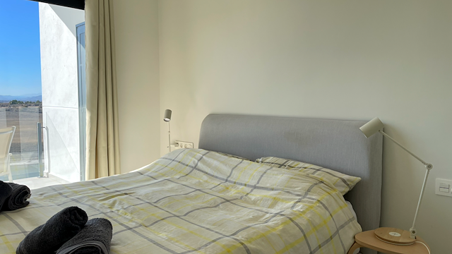 A bedroom with the course outside